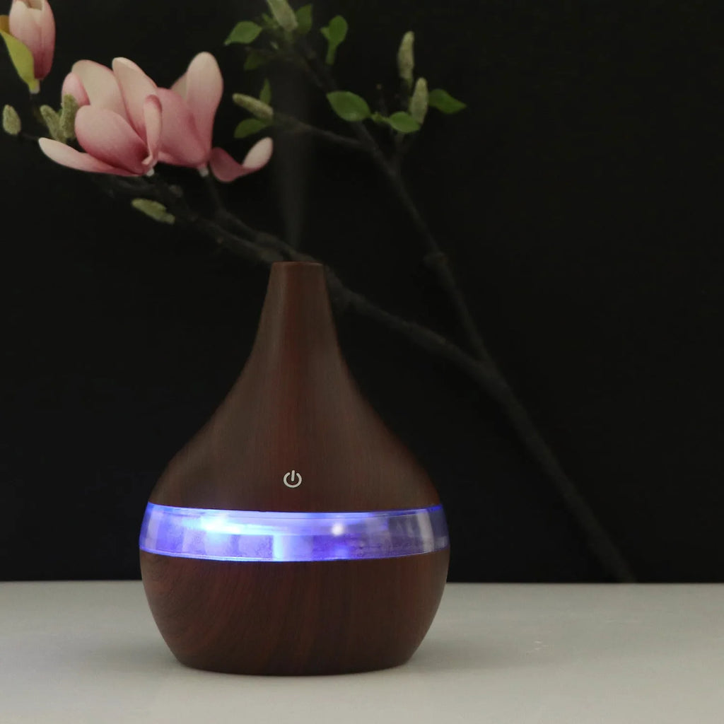 USB-powered mini humidifier in columnar design with wood grain finish and remote control
