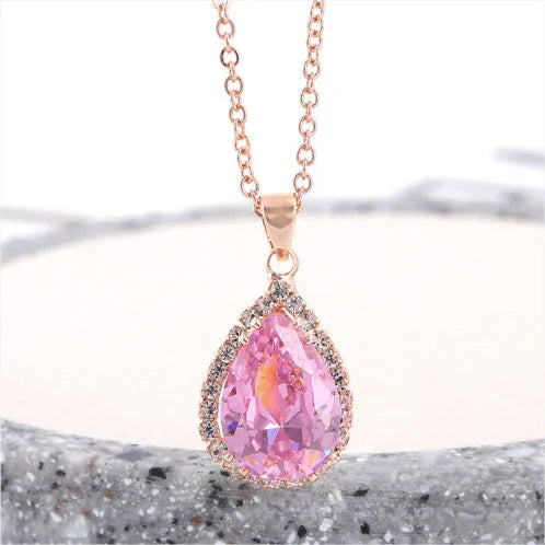 Women's pink alloy water drop necklace with geometric design and rose gold rhinestones on model