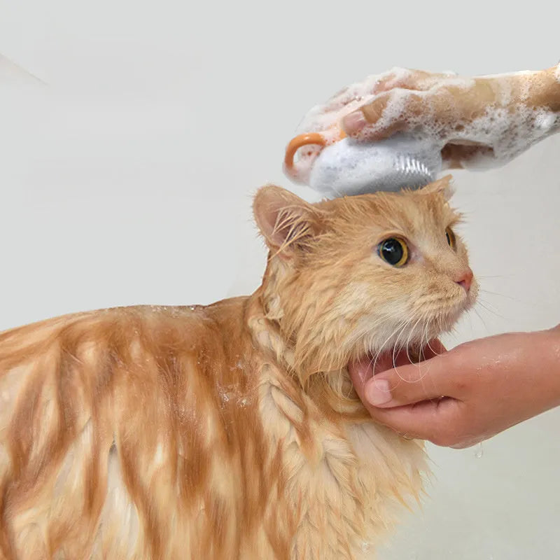 Orange dog bath brush with shampoo dispenser and soft TPR bristles on a curved pumpkin-shaped handle.