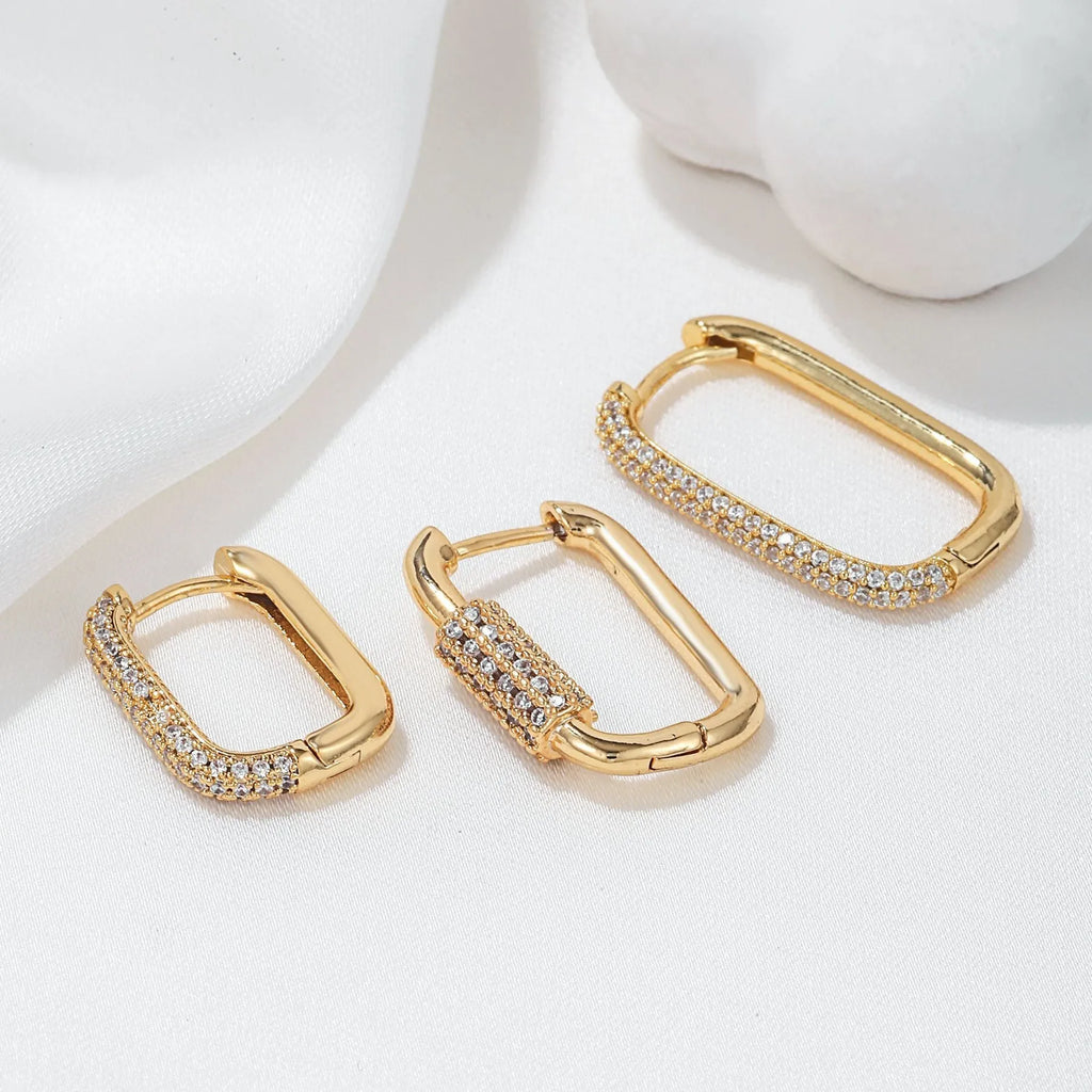 Set of three geometric square clip-on earrings with inlaid zircon detail in gold and white gold tones.