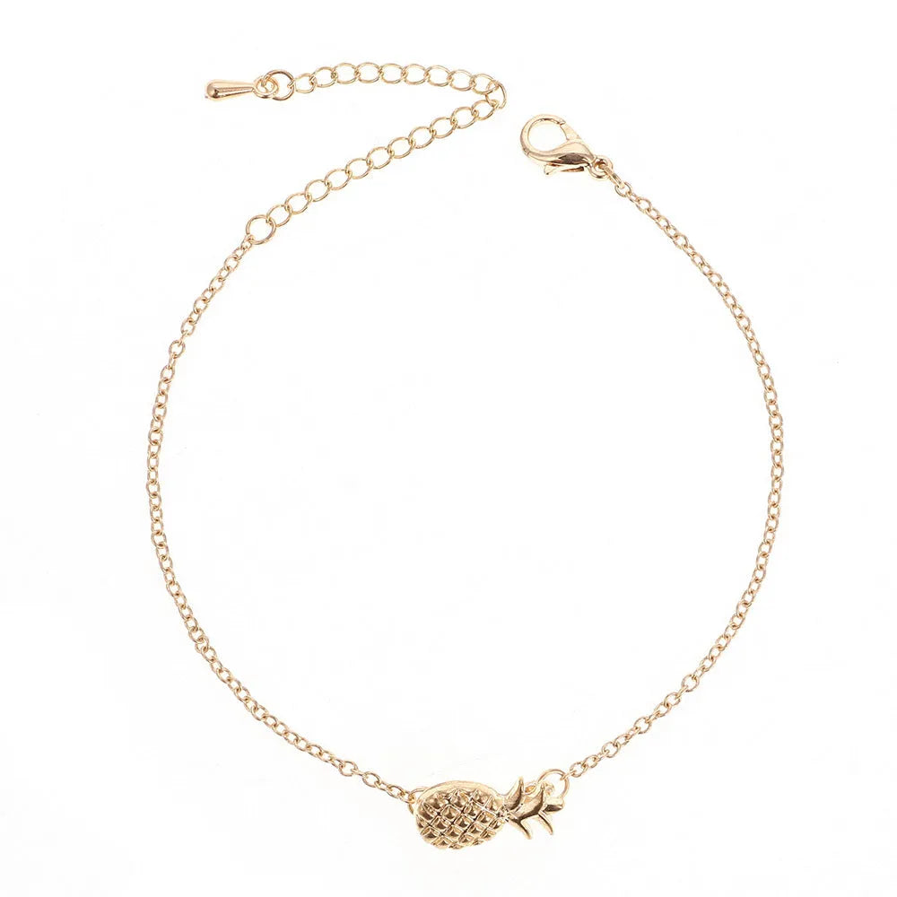Close-up of a women's alloy bracelet featuring a detailed pineapple charm in a gold or silver tone.