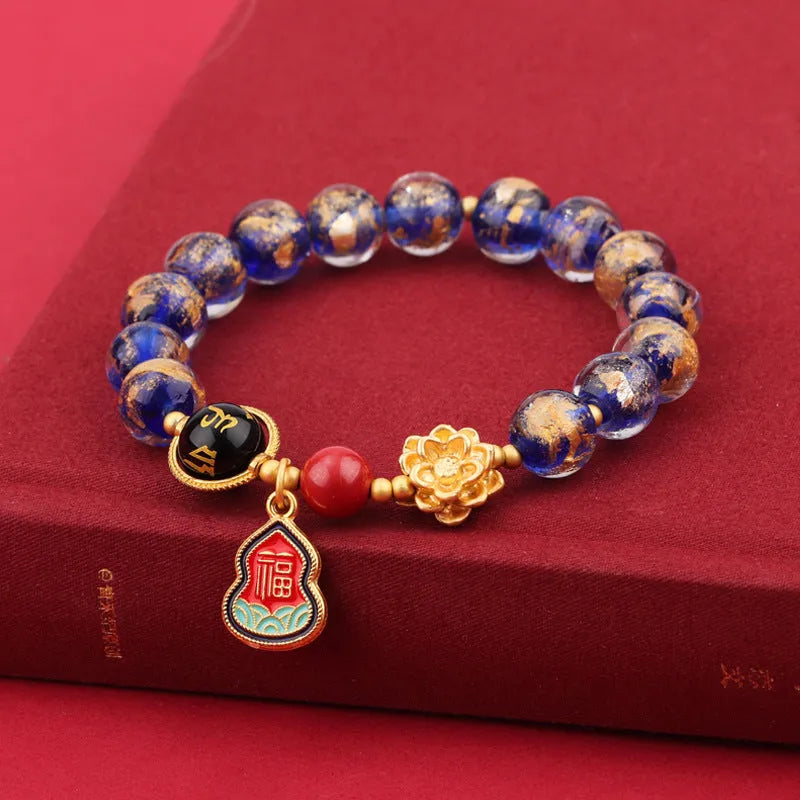 Gold foil Lotus Blessing card charm on a fragrant glazed 8mm bead bracelet for women.