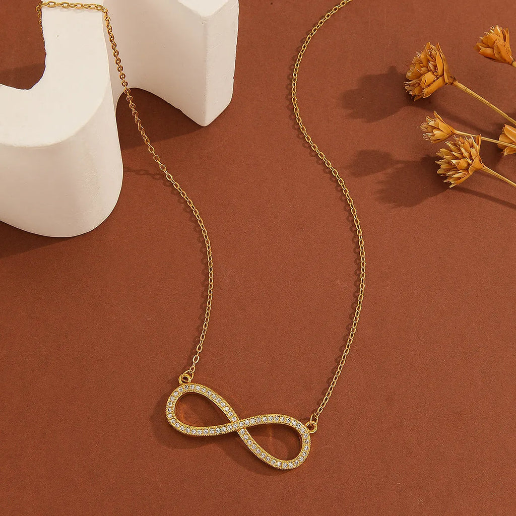 Gold plated copper infinity symbol pendant necklace with sparkling diamond inlay and gold fine chain