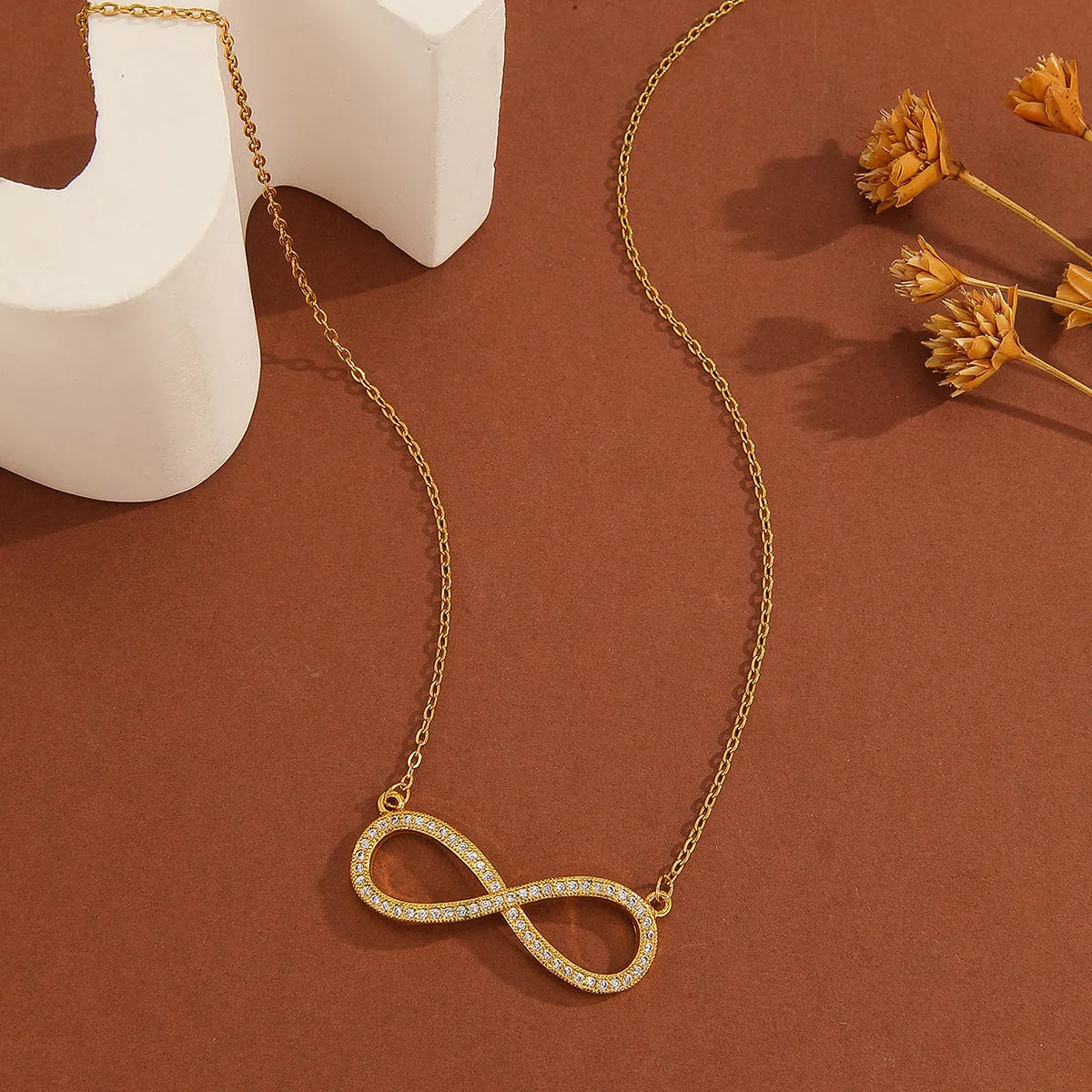 Gold plated copper infinity symbol pendant necklace with sparkling diamond inlay and gold fine chain
