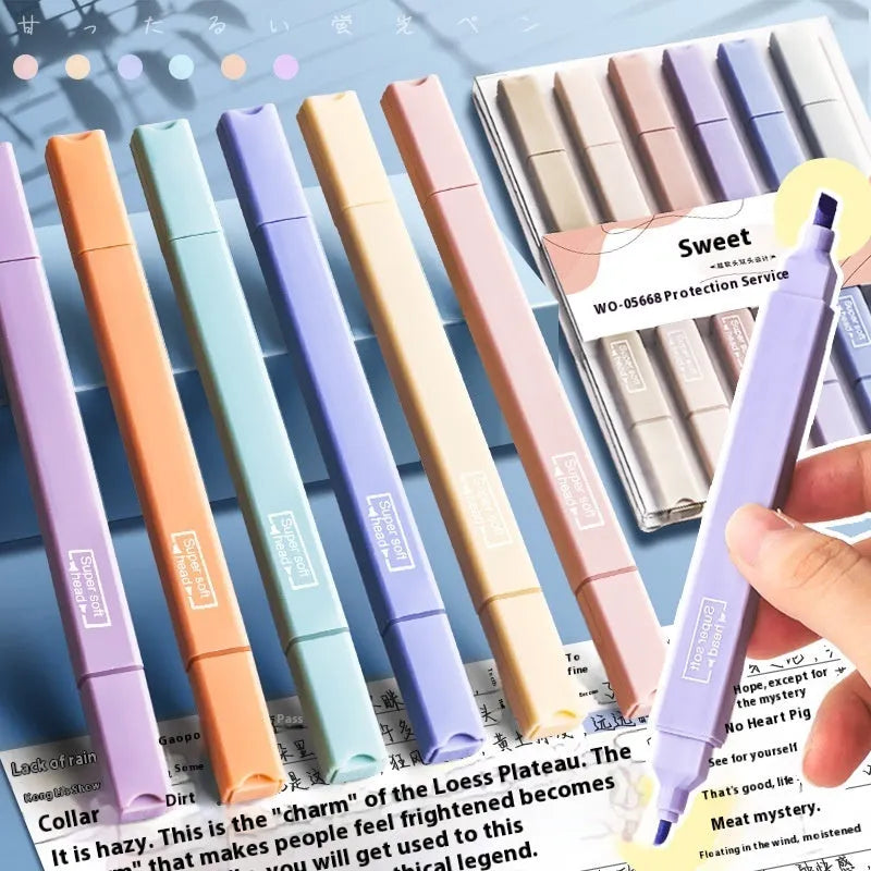 Set of double-ended fluorescent highlighting pens in mixed colours on a white surface.