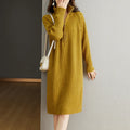 Beige casual skirt with half front zipper, stand collar, and long sleeves on a mannequin.