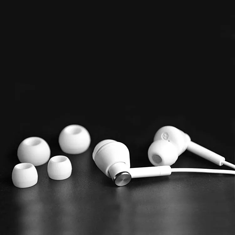 Black and white wired in-ear earphones with 3.5mm audio jack for computer and mobile phone connectivity