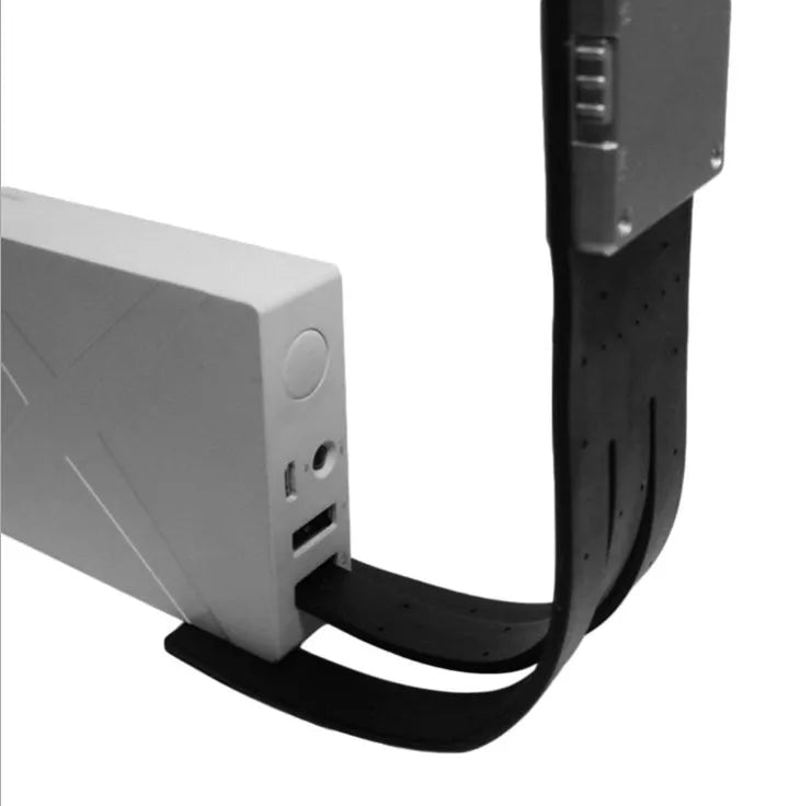Black folding LED reading lamp clipped to a Kindle e-reader showing adjustable brightness settings