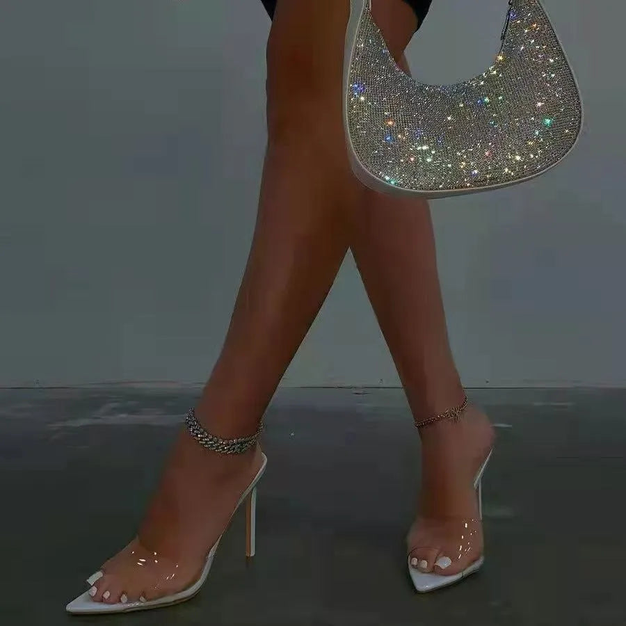 Women's black ultra-high vamp stiletto heel slippers with a pointed toe on a rubber sole.