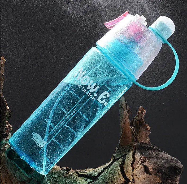 Green portable outdoor sports mist spray cup with handle, transparent scale, and spray mouth.
