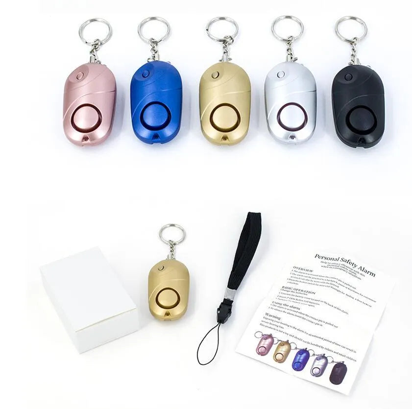 High decibel personal alarm pager keyring with 130dB siren, LED flashlight, and lanyard activation in black.