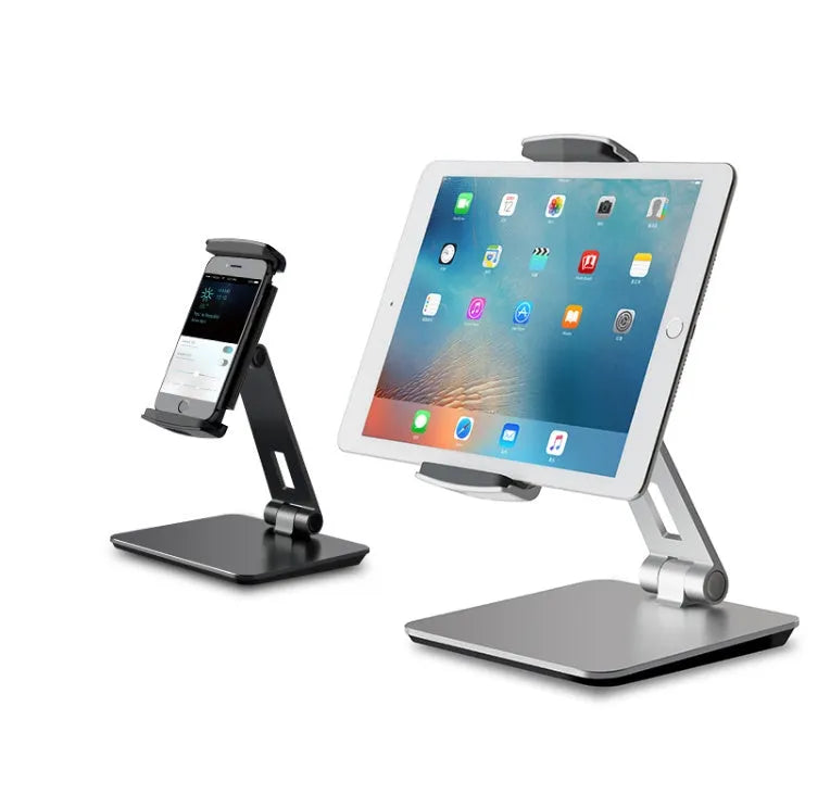 Silver foldable aluminium and ABS phone and tablet stand on a desk, showing 360-degree rotation.