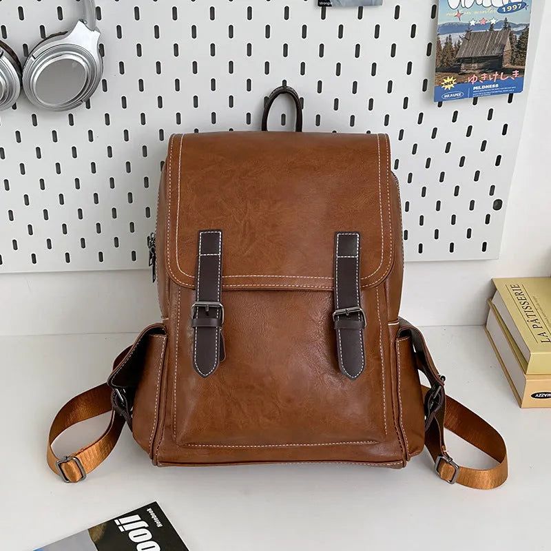 Retro leather travel backpack in black, dark brown, or brown with curved shoulder straps and 20-35L capacity