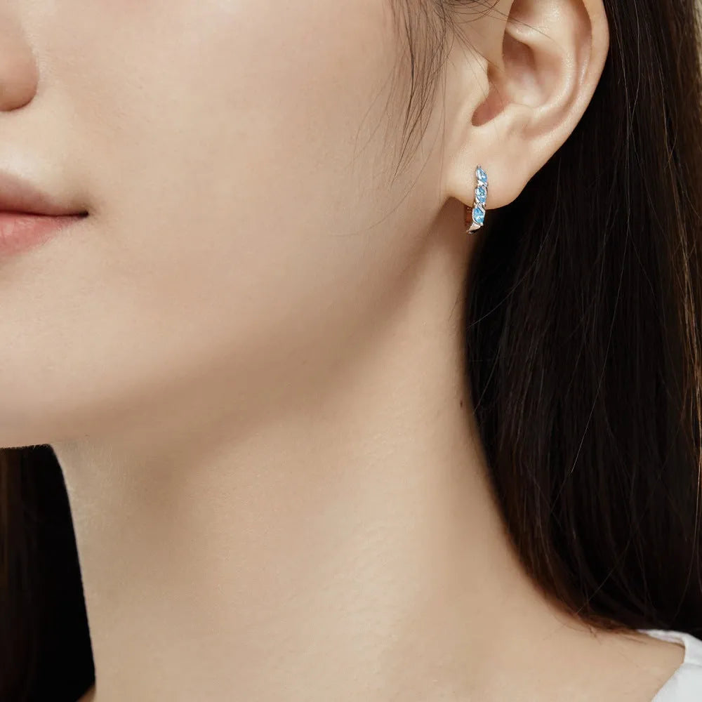 Women's blue zircon inlaid symmetrical earrings in 925 silver with electroplated platinum blue diamond colour, 3x14x15mm.