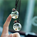 Car pendant perfume bottle with 2.8cm high borosilicate glass ball and Brazilian small star flower in Blue, Green, Pink, or White.