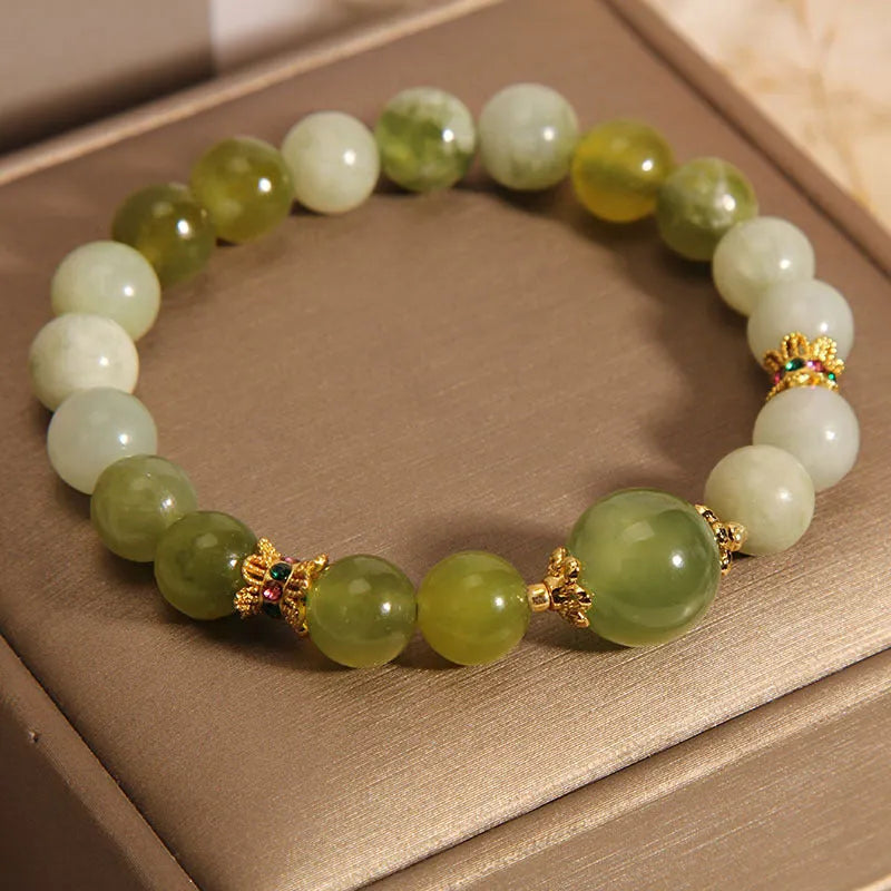 Women's bracelet made of green Xiuyan jade with an original design on a wrist.