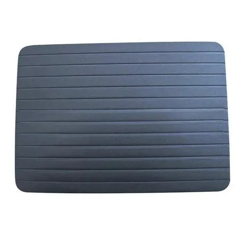 Black aluminium fast defrosting tray for kitchen use on a countertop