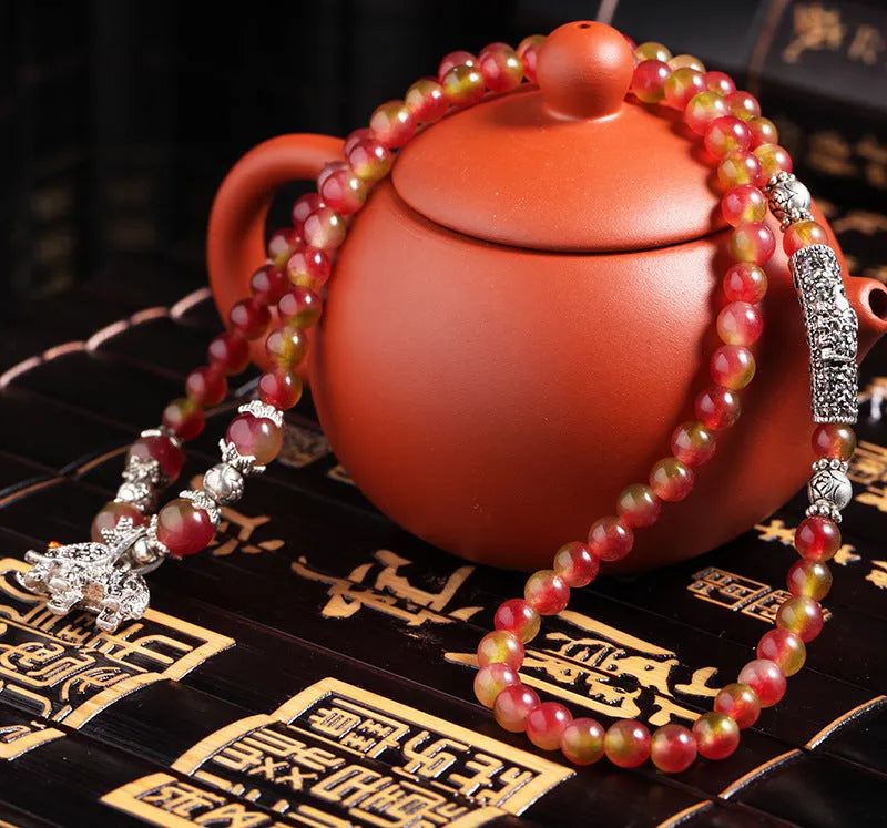 Handmade natural watermelon crystal Chinese knot bracelet in geometric elephant style.
