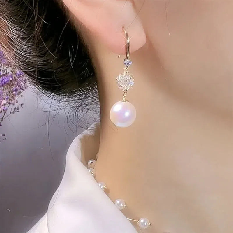 Personalised pearl earrings with red bean accent in a drop style, available in two options.