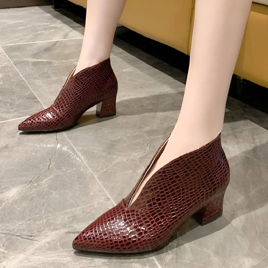 Women's black ankle boots with V-cut design, embossed texture, and chunky heel