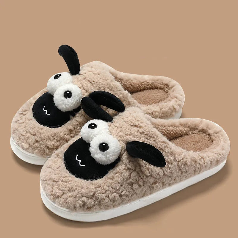 Brown unisex slip-on slippers with suede upper and light sole on a wooden floor.