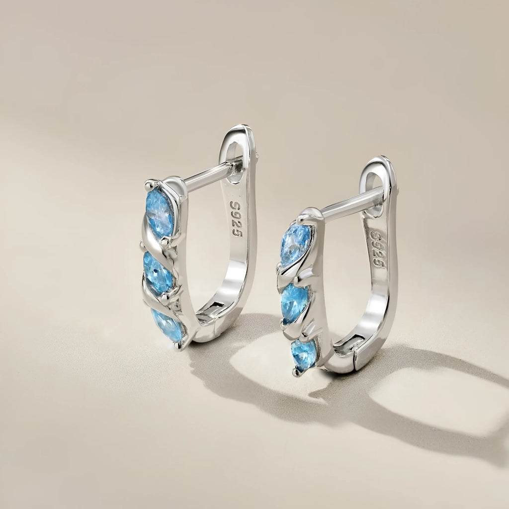 Women's blue zircon inlaid symmetrical earrings in 925 silver with electroplated platinum blue diamond colour, 3x14x15mm.