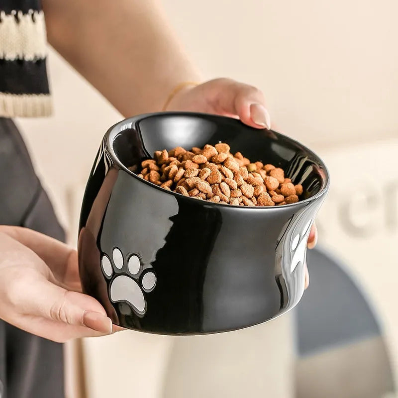Ceramic cat bowl with oblique mouth and high foot in cat's paw black colour