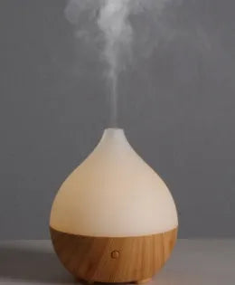 Asakusa wood grain finish vase-shaped 100ml USB aroma diffuser on a surface.