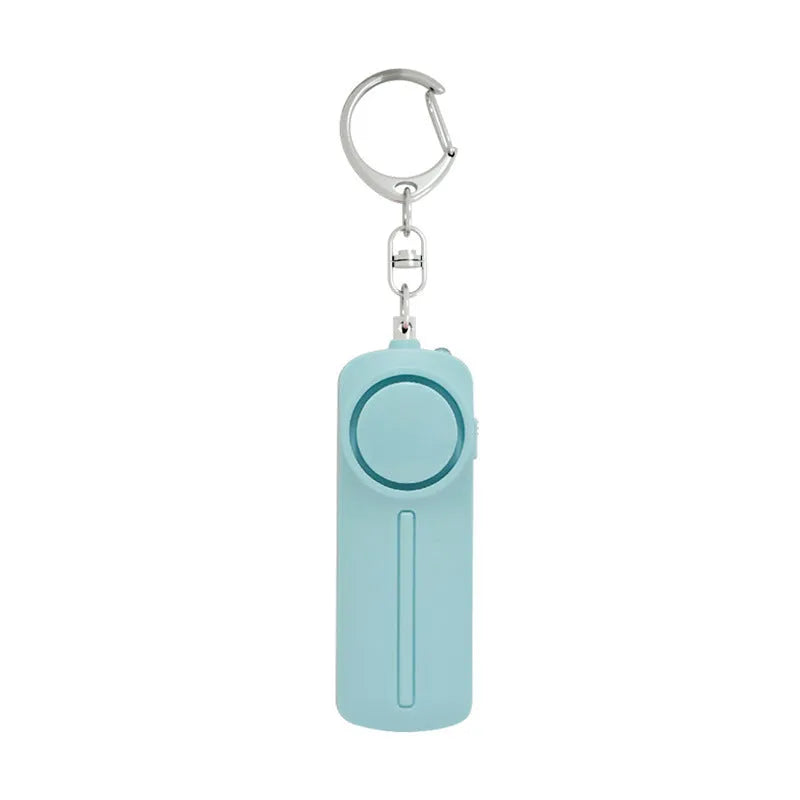 Girls personal safety alarm in pink colour showing compact size with activation button.