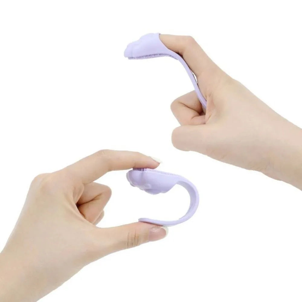 Silicone fingertip toothbrush for pets in pink, purple, and yellow, shown on a finger.