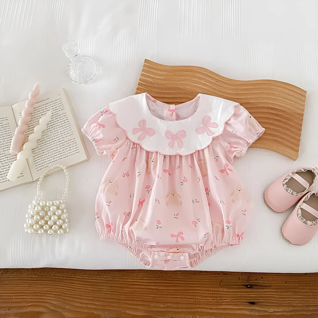 Pink cotton newborn triangle rompers with short sleeves and three bow details for summer outwear