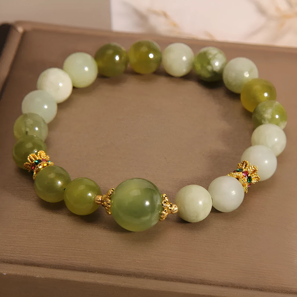 Women's bracelet made of green Xiuyan jade with an original design on a wrist.
