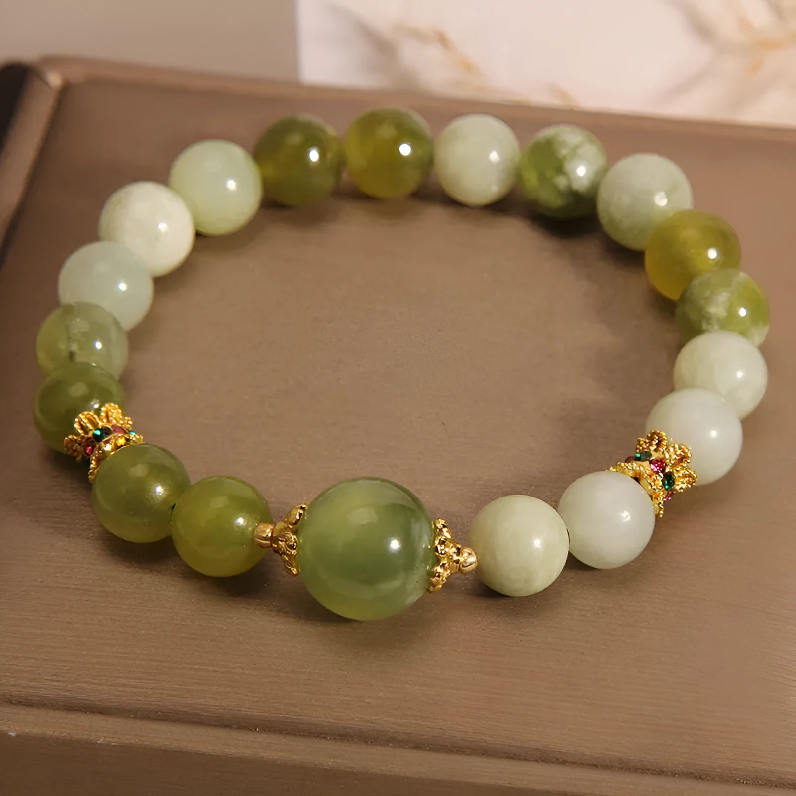 Women's bracelet made of green Xiuyan jade with an original design on a wrist.