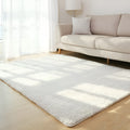 White plush lambswool rectangular area rug with non-slip dotted bottom on wooden floor