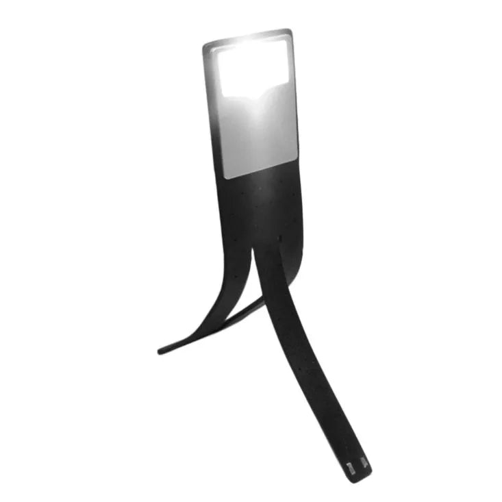 Black folding LED reading lamp clipped to a Kindle e-reader showing adjustable brightness settings