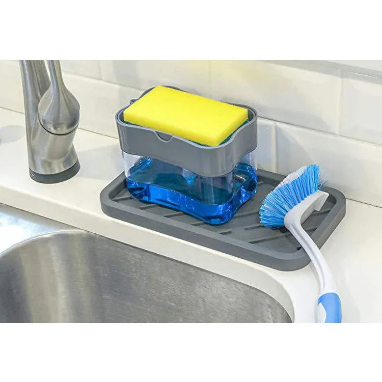A grey automatic touch-free soap dispenser for the kitchen on a worktop.