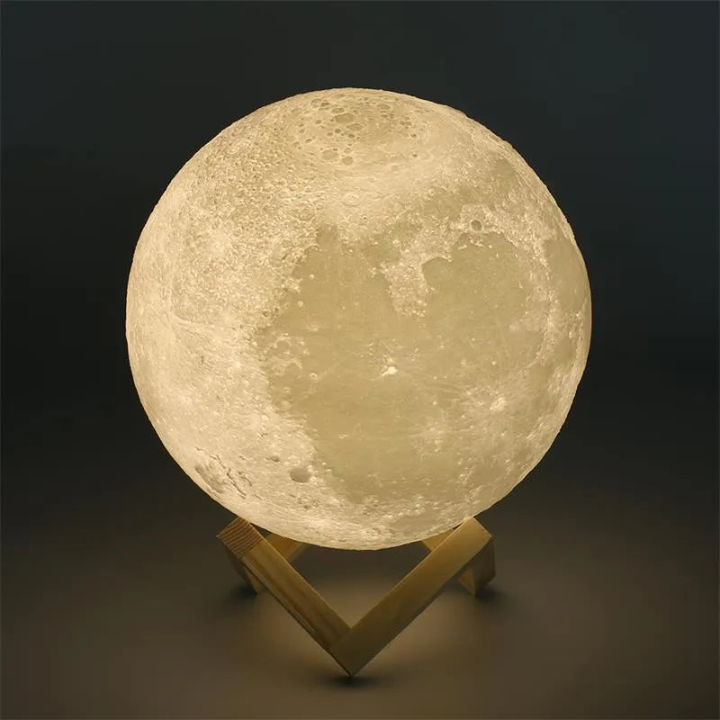 3D printed white moon lamp glowing on a wooden stand, showing detailed lunar craters.