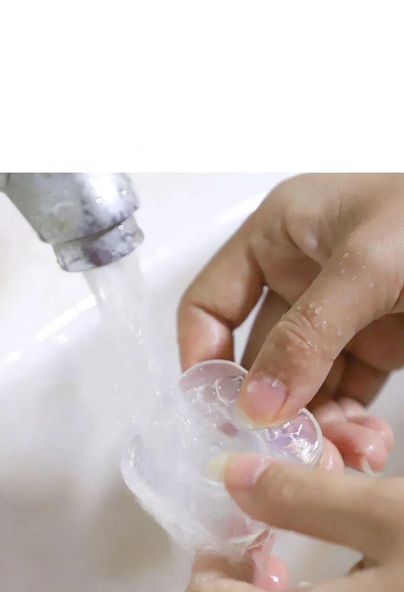Transparent reusable nano gel adhesive pads in circular and square shapes on a smooth surface