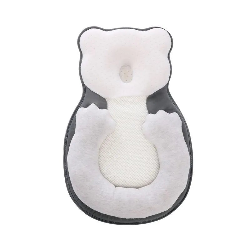 Folded portable baby travel bed with a soft beige cotton sleep cushion for newborns