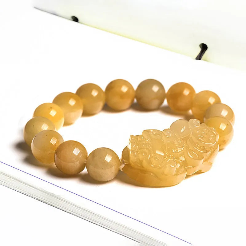 Golden Thread Jinsi Jade bracelet with a carved fortune coin and round jade beads in two size options.