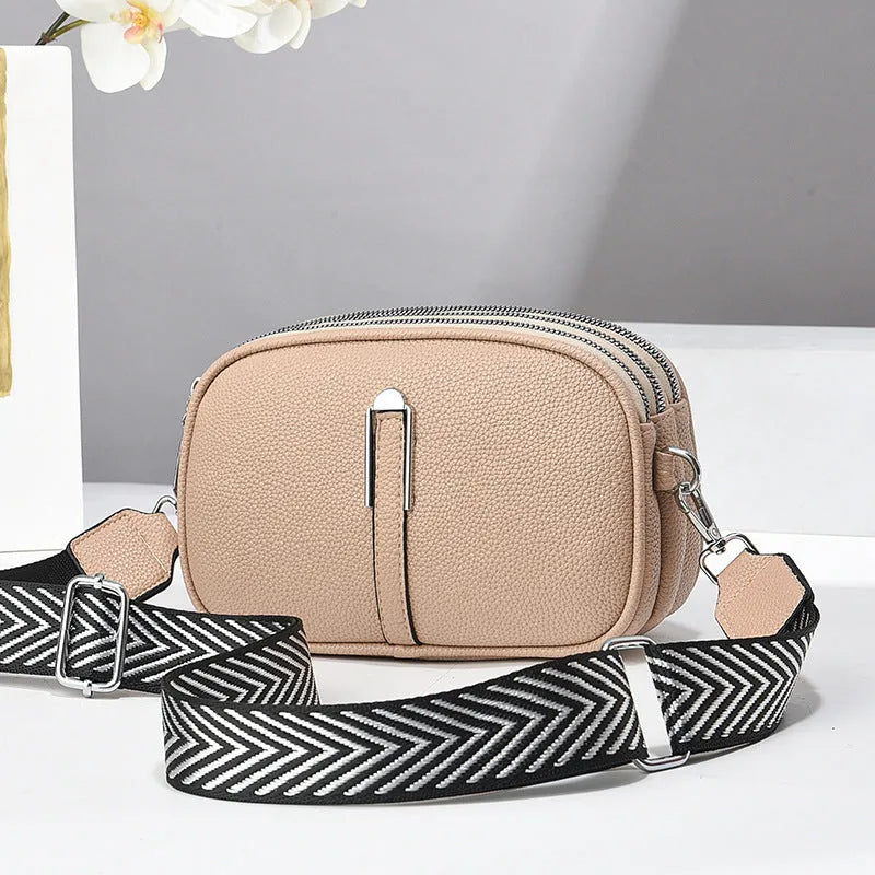 Soft oval PU leather crossbody handbag with stone pattern and internal organiser compartments.