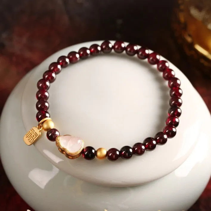 Chinese style gourd bracelet with imitation garnet beads and Fu character charms in U-shaped design