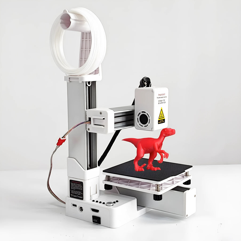 White EasyThreed K10 3D printer on a desktop with power cord and manual.