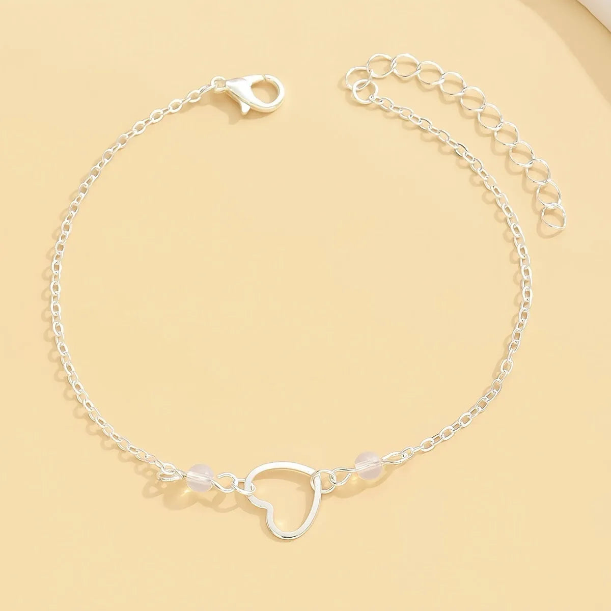 Adjustable gold alloy anklet with heart-shaped pendant on geometric chain