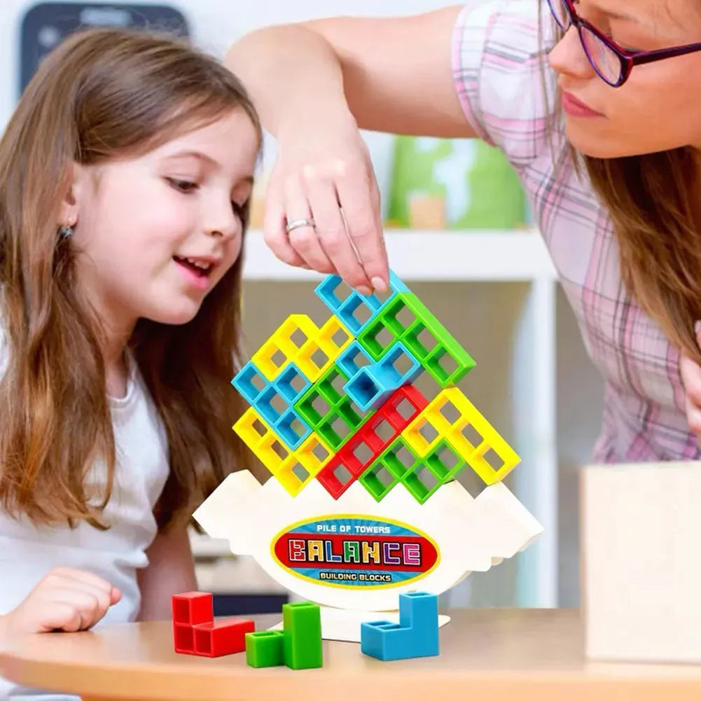 Plastic balance stacking game with coloured building blocks, chassis, and base on a table