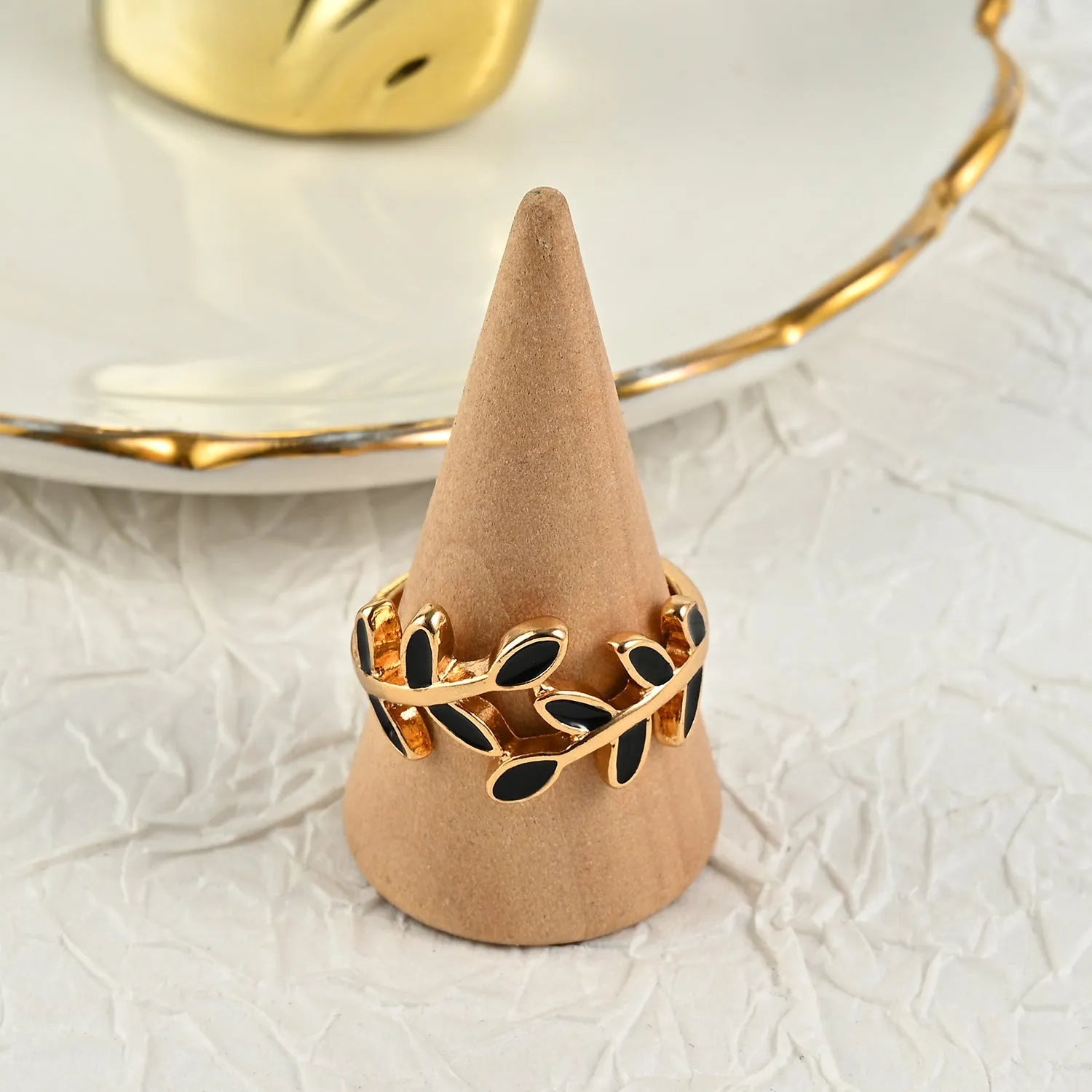 Gold geometric leaf and floral acrylic ring for women on a white background.