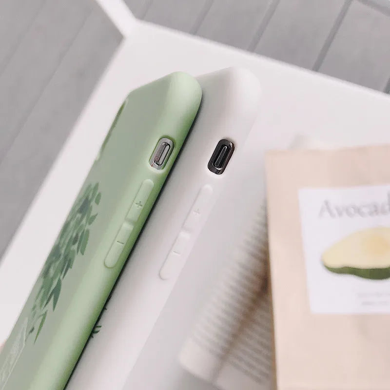 White silicone iPhone case with a detailed painted botanical plant design on the back.