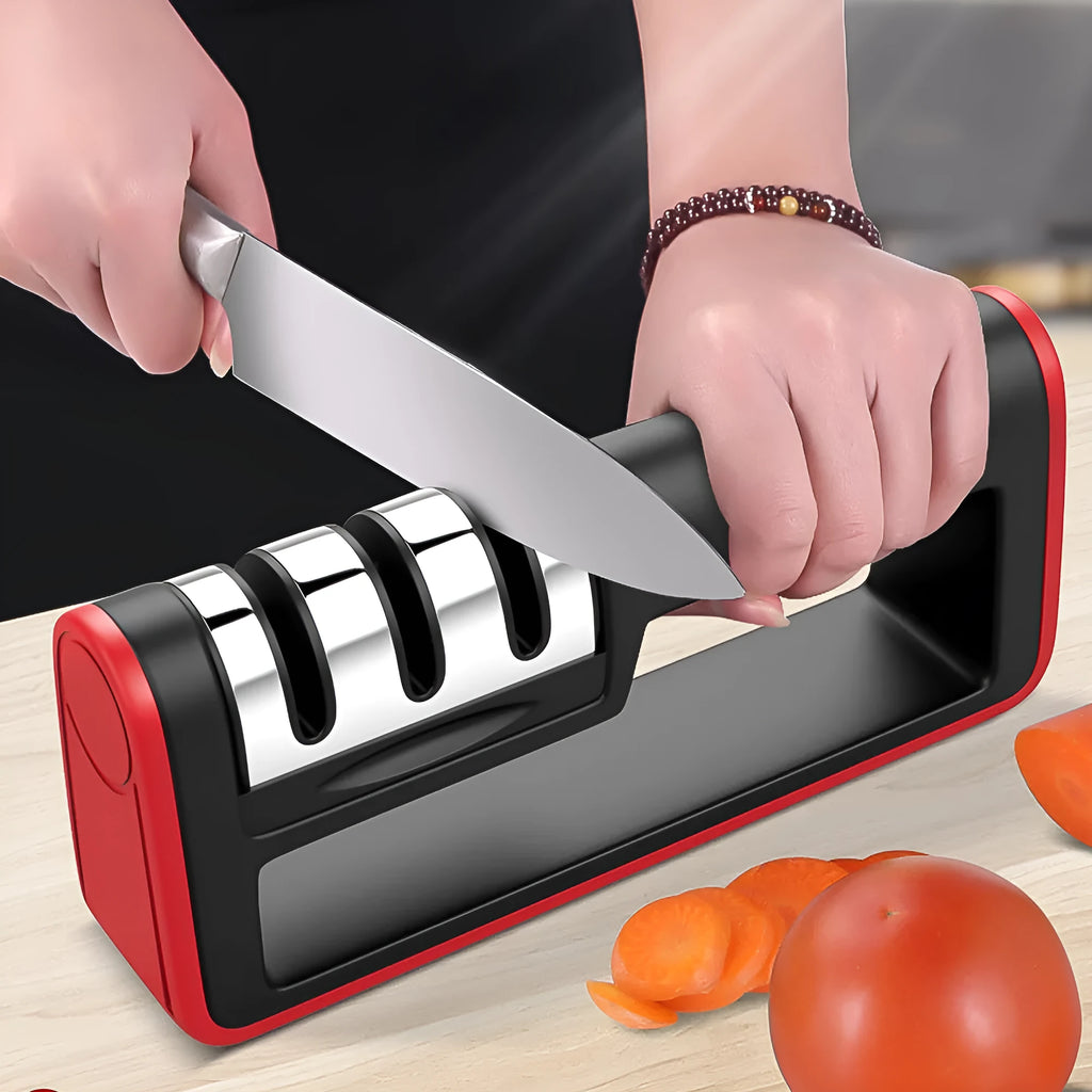 Black and red three-stage manual knife sharpener with rubber feet on base