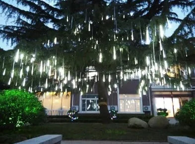 Waterproof blue LED meteor shower tube light creating a raining light effect outdoors.
