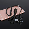Wired in-ear earphones with 3.5mm audio jack and microphone, black colour, on white background.
